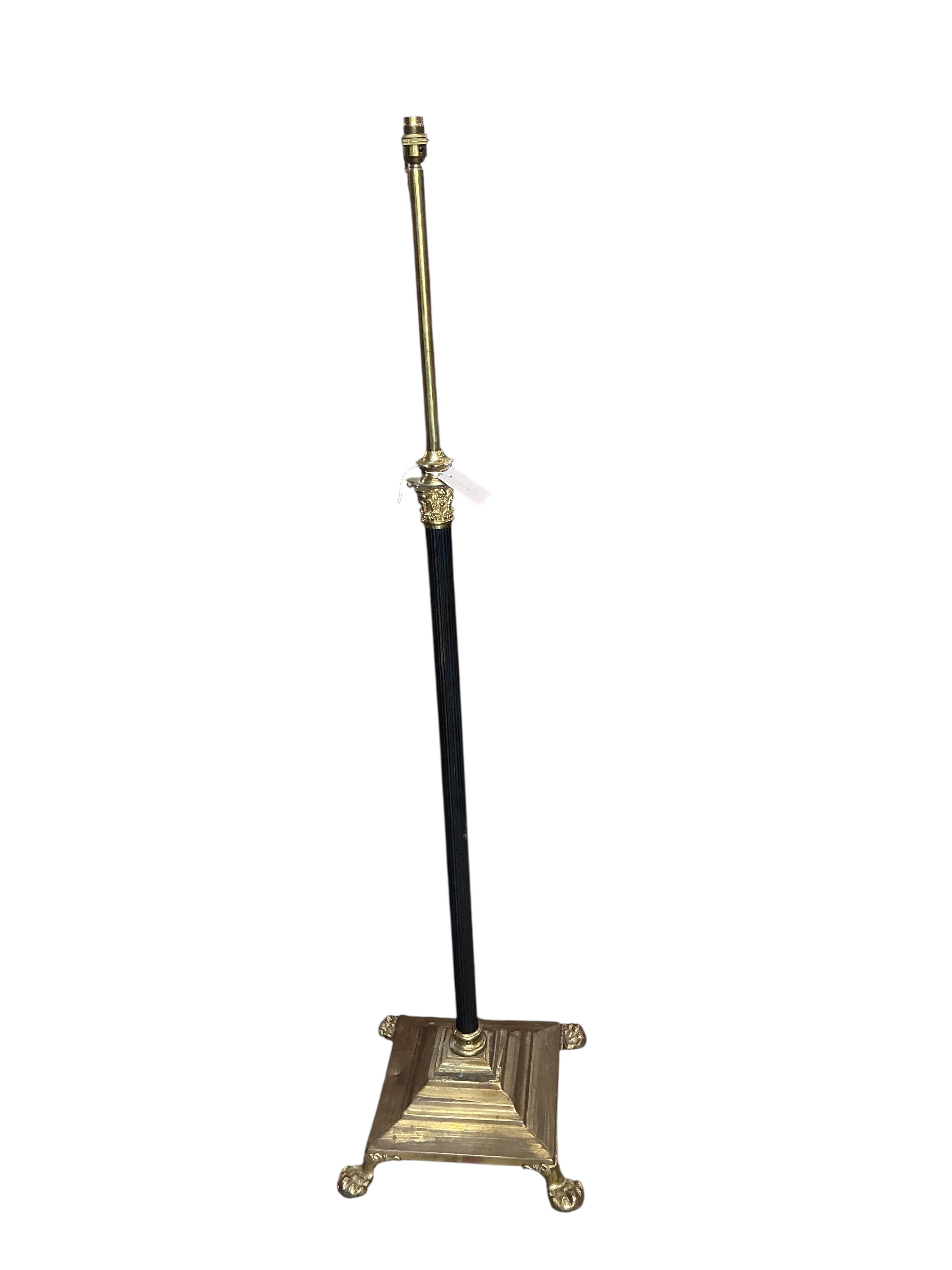 An Edwardian brass telescopic standard lamp on lion's paw feet